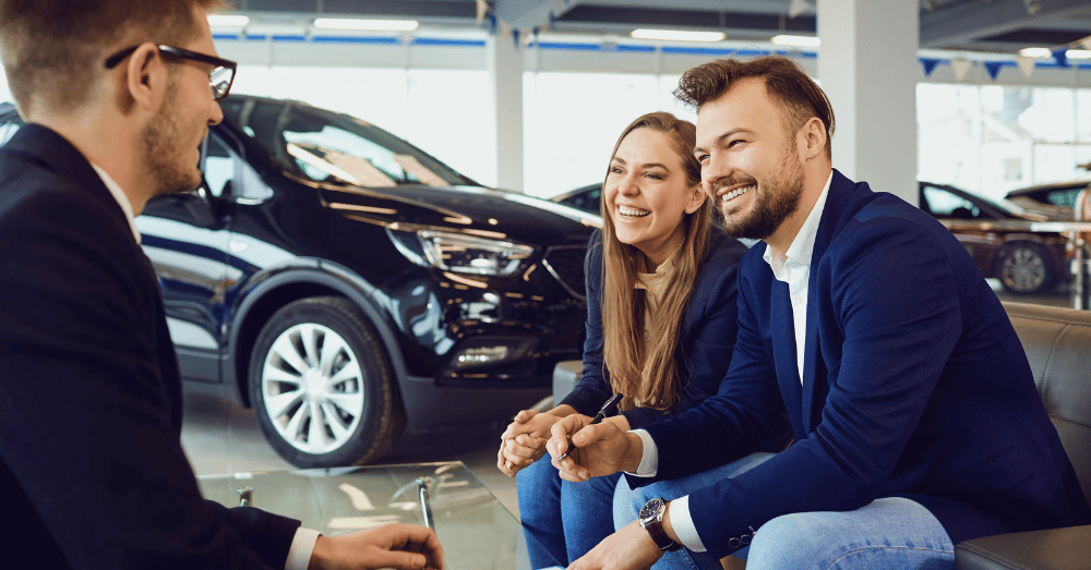 The Changing Face of Car Buying_ From Showroom to Smartphone - couple buying a car in a showroom